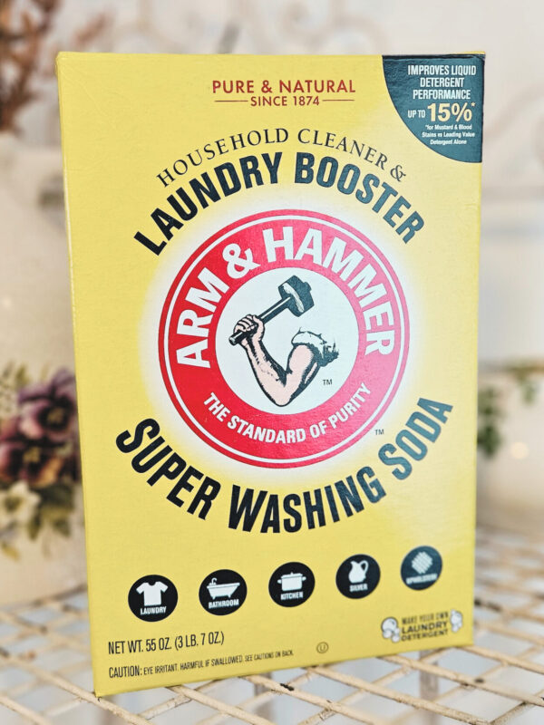 A box of washing soda sitting on a metal shelf.