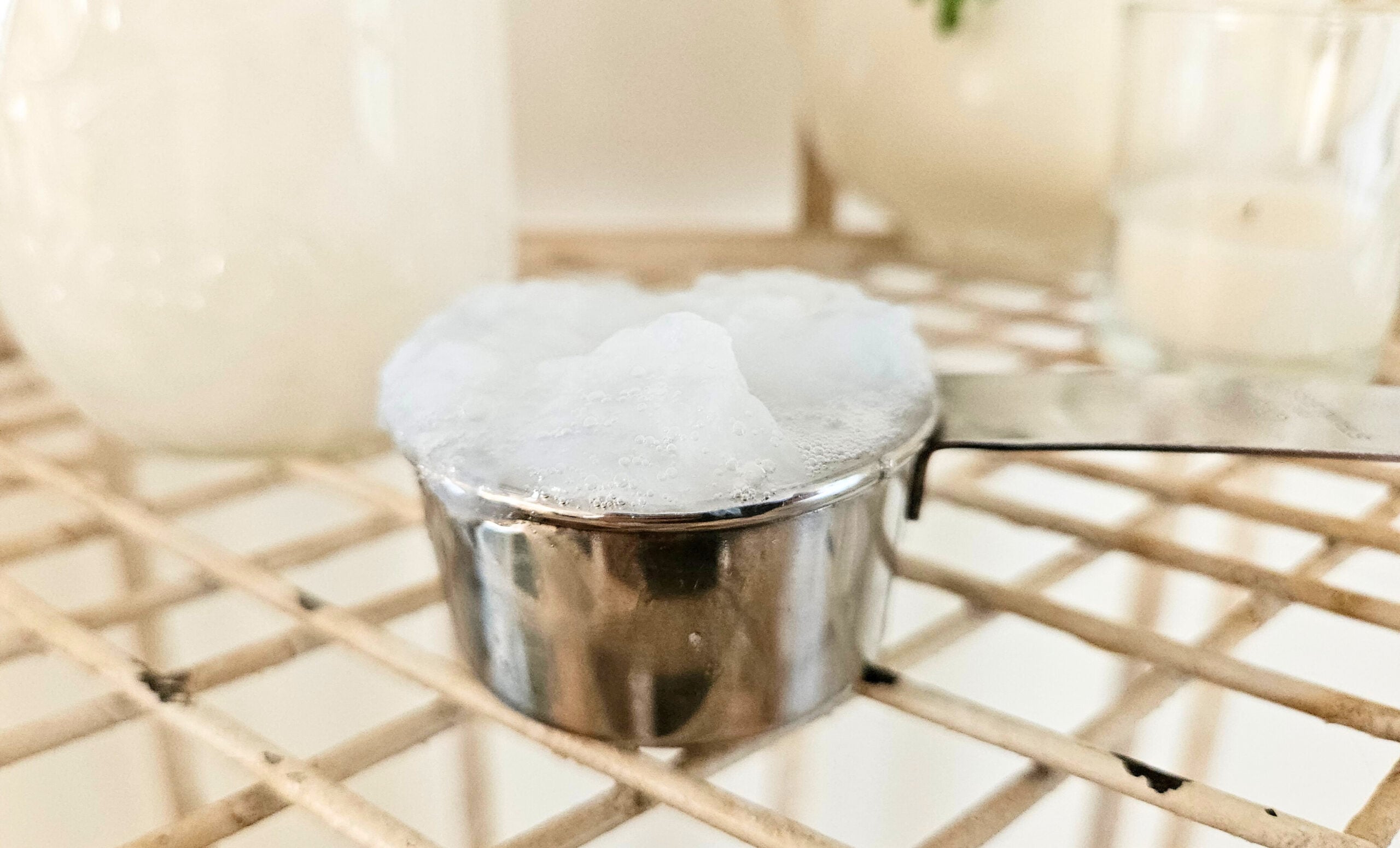 Quarter cup thick white laundry detergent.