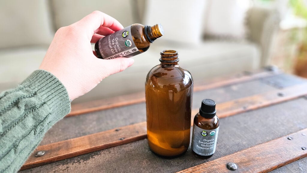 Add tea tree essential oil to an amber glass spray bottle.