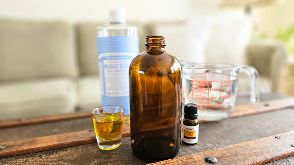 Amber glass spray bottle, liquid castile soap, olive oil. lemon essential oil, and water.